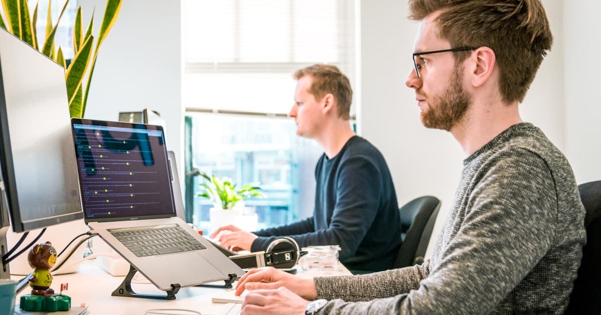 Team collaborating at a table with laptops—representing platform engineering and unified gateway strategy